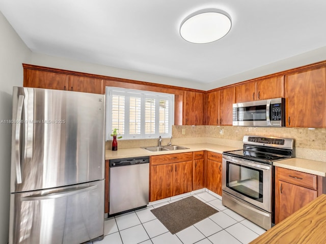 6566 NW 197th Ln, Hialeah, FL 33015 - kitchen with appliances with stainless steel finishes, a sink, light countertops, tasteful backsplash, and brown cabinets