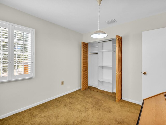 6566 NW 197th Ln, Hialeah, FL 33015 - unfurnished bedroom featuring carpet floors, a closet, and baseboards