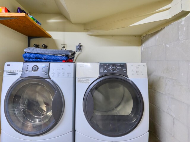 6566 NW 197th Ln, Hialeah, FL 33015 - laundry room with washer and dryer and concrete block wall