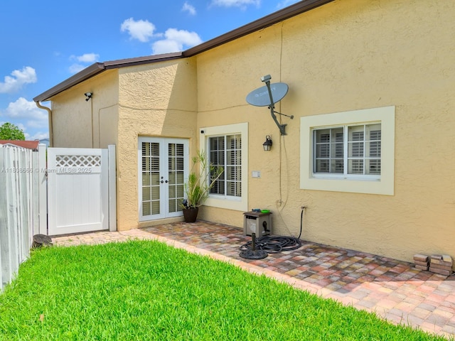 6566 NW 197th Ln, Hialeah, FL 33015 - property entrance with french doors, a patio area, and stucco siding