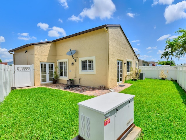 6566 NW 197th Ln, Hialeah, FL 33015 - back of property featuring french doors, stucco siding, central AC unit, and a patio