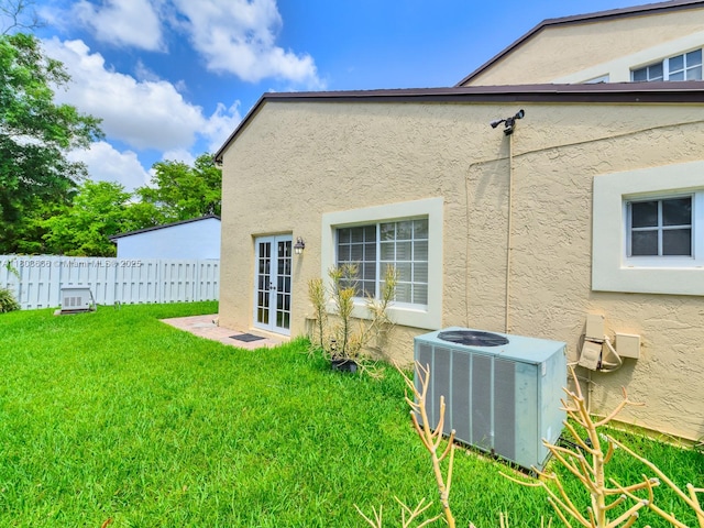 6566 NW 197th Ln, Hialeah, FL 33015 - rear view of property with central AC, stucco siding, and french doors