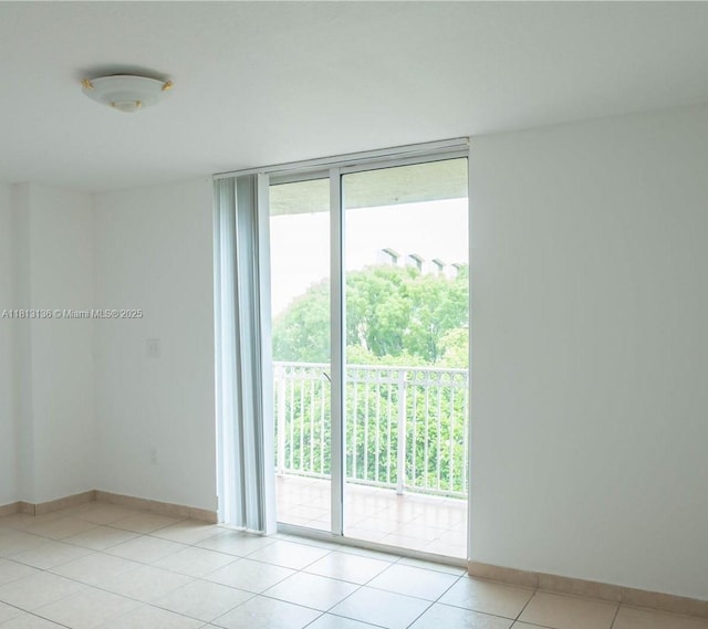 1650 Coral Way Unit 512, Miami, FL 33145 - unfurnished room with healthy amount of natural light, expansive windows, baseboards, and light tile patterned floors