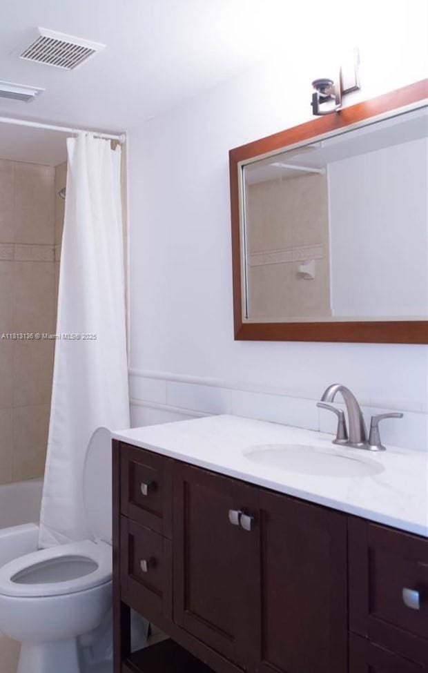1650 Coral Way Unit 512, Miami, FL 33145 - full bathroom featuring vanity, toilet, and shower / bathtub combination with curtain