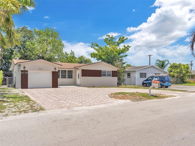 6525 SW 18th St, Miramar, FL 33023 - ranch-style home with decorative driveway, a garage, and stucco siding