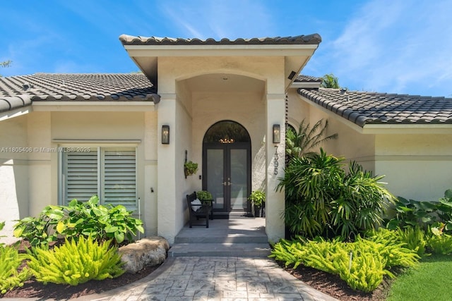 7395 SW 166th St, Palmetto Bay, FL 33157 - property entrance with french doors, a tiled roof, and stucco siding