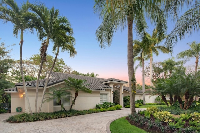 7395 SW 166th St, Palmetto Bay, FL 33157 - mediterranean / spanish-style home featuring a tile roof, curved driveway, and stucco siding