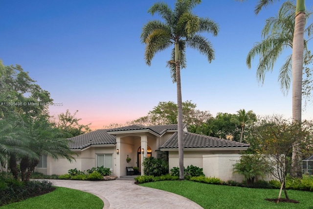 7395 SW 166th St, Palmetto Bay, FL 33157 - mediterranean / spanish-style home with a tiled roof, stucco siding, curved driveway, and a lawn