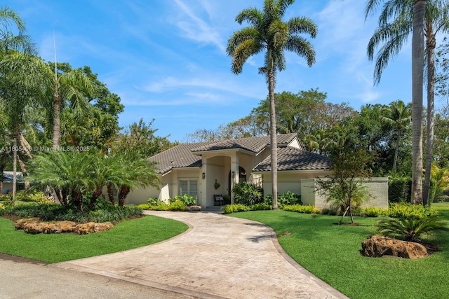 7395 SW 166th St, Palmetto Bay, FL 33157 - mediterranean / spanish-style house featuring a tile roof, a front yard, stucco siding, and decorative driveway
