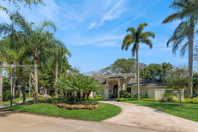 7395 SW 166th St, Palmetto Bay, FL 33157 - mediterranean / spanish-style house featuring decorative driveway, stucco siding, a tile roof, and a front lawn