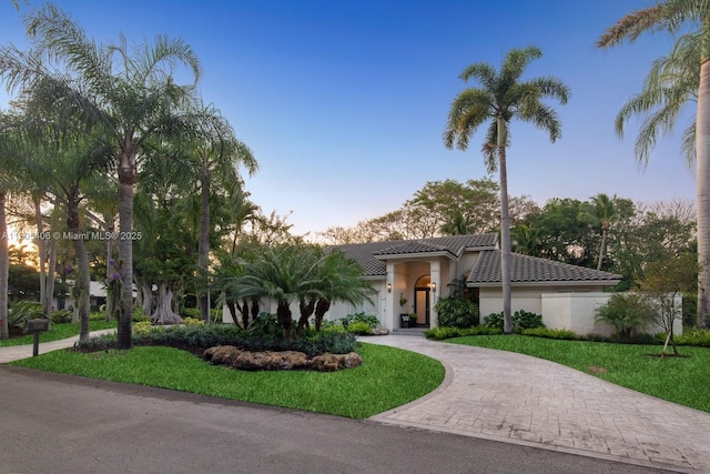 7395 SW 166th St, Palmetto Bay, FL 33157 - view of front of home featuring decorative driveway, a tiled roof, stucco siding, and a front lawn