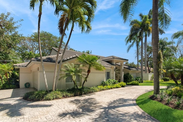 7395 SW 166th St, Palmetto Bay, FL 33157 - view of front facade with decorative driveway, a tiled roof, and stucco siding