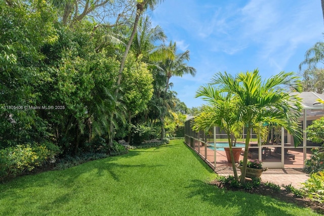 7395 SW 166th St, Palmetto Bay, FL 33157 - view of green lawn with an outdoor pool, a patio, and glass enclosure