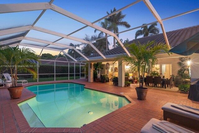 7395 SW 166th St, Palmetto Bay, FL 33157 - pool at dusk featuring an outdoor pool and a patio area
