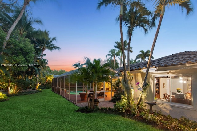 7395 SW 166th St, Palmetto Bay, FL 33157 - rear view of property featuring a patio, a lawn, an outdoor pool, a tiled roof, and stucco siding