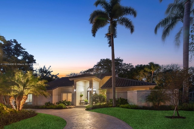 7395 SW 166th St, Palmetto Bay, FL 33157 - view of front of home with curved driveway, stucco siding, a front lawn, and a tiled roof