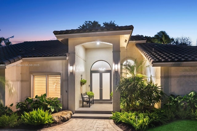 7395 SW 166th St, Palmetto Bay, FL 33157 - property entrance with a tiled roof, stucco siding, and french doors