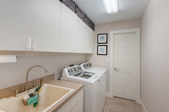 7395 SW 166th St, Palmetto Bay, FL 33157 - laundry area featuring independent washer and dryer, cabinet space, light wood finished floors, and baseboards