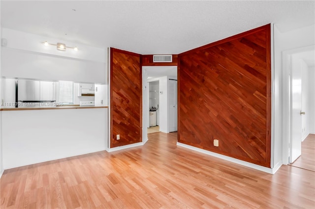 9906 Twin Lakes Dr Unit 7-I, Coral Springs, FL 33071 - unfurnished living room featuring light wood-style flooring, wooden walls, and baseboards