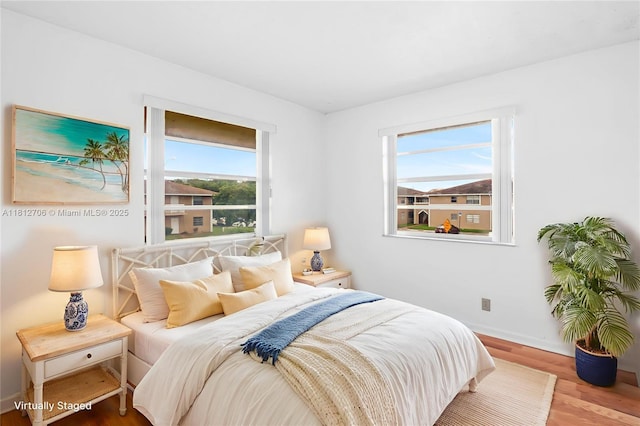 9906 Twin Lakes Dr Unit 7-I, Coral Springs, FL 33071 - bedroom with multiple windows, wood finished floors, and baseboards