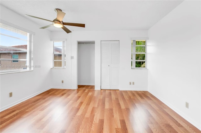 9906 Twin Lakes Dr Unit 7-I, Coral Springs, FL 33071 - unfurnished bedroom featuring multiple closets, light wood-type flooring, baseboards, and a ceiling fan