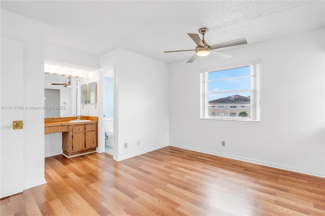 9906 Twin Lakes Dr Unit 7-I, Coral Springs, FL 33071 - unfurnished bedroom with a sink, light wood-style floors, a desk, and baseboards