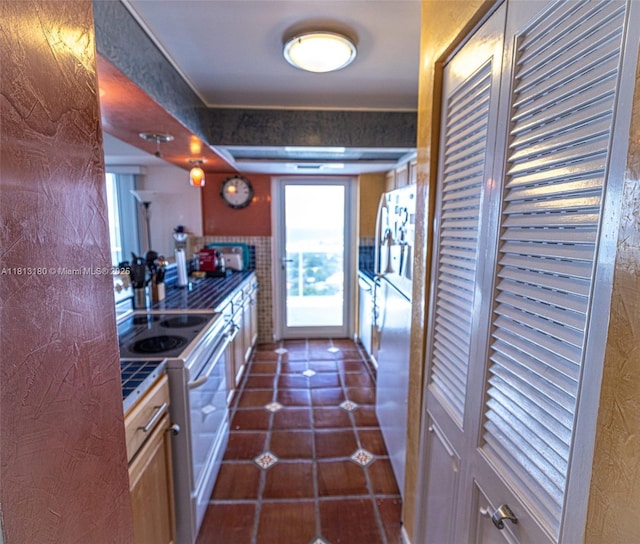 2841 N Ocean Blvd Unit 1801, Fort Lauderdale, FL 33308 - kitchen with appliances with stainless steel finishes, tile counters, and dark tile patterned flooring