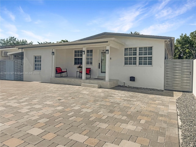 350 W 16th St, Hialeah, FL 33010 - view of front of home featuring covered porch and stucco siding