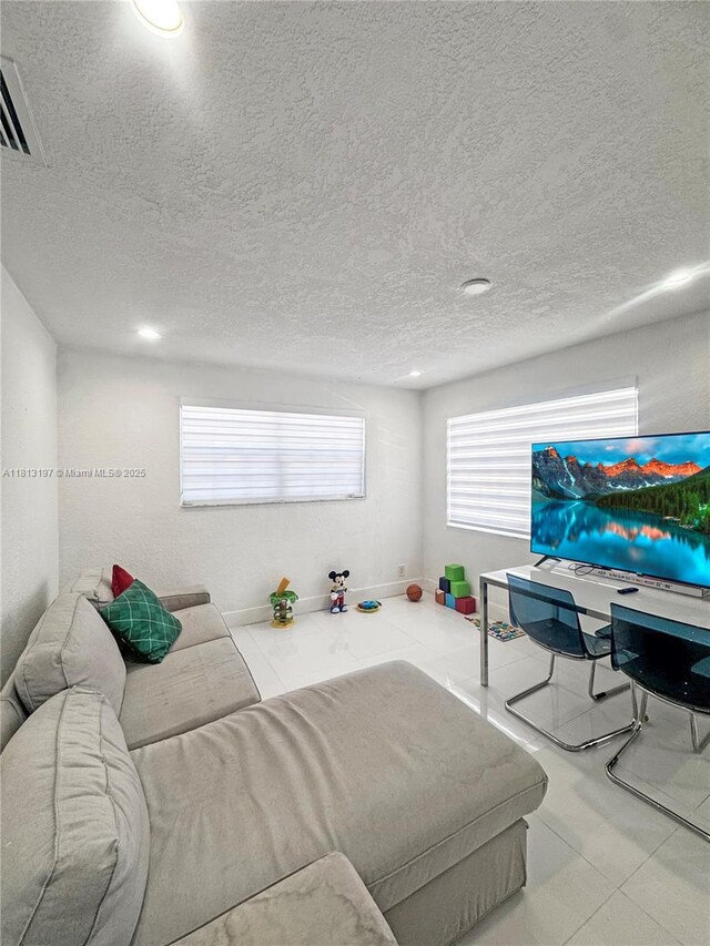 350 W 16th St, Hialeah, FL 33010 - living room featuring tile patterned flooring, a textured ceiling, and recessed lighting
