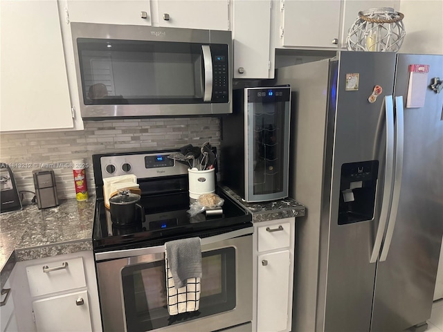 20810 NE 8th Ct Unit 201-18, Miami, FL 33179 - kitchen featuring stainless steel appliances, white cabinets, backsplash, and dark countertops
