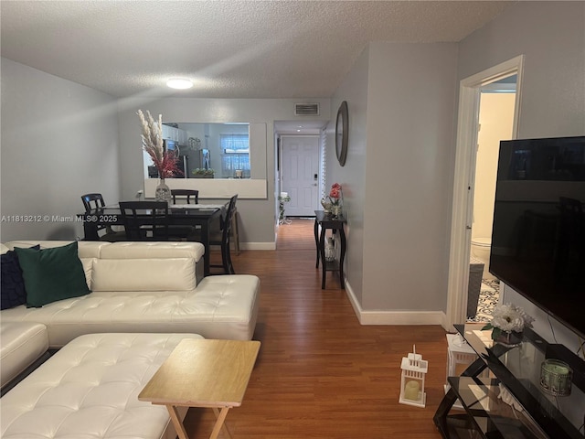 20810 NE 8th Ct Unit 201-18, Miami, FL 33179 - living room featuring wood finished floors, a textured ceiling, and baseboards