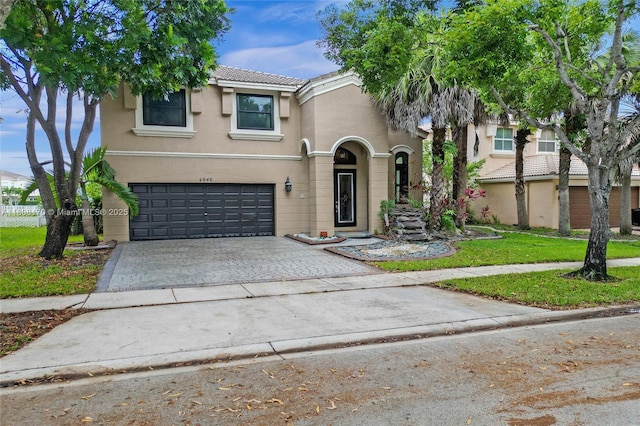 4946 SW 166th Ave, Miramar, FL 33027 - view of front facade with driveway, a garage, stucco siding, and a tile roof
