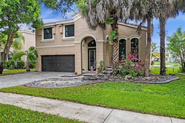 4946 SW 166th Ave, Miramar, FL 33027 - mediterranean / spanish home with an attached garage, stucco siding, driveway, and a front lawn