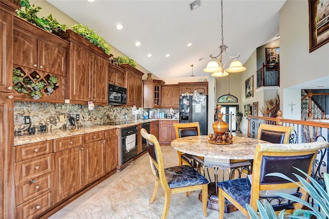 4946 SW 166th Ave, Miramar, FL 33027 - kitchen with black appliances, decorative backsplash, lofted ceiling, hanging light fixtures, and light marble finish flooring