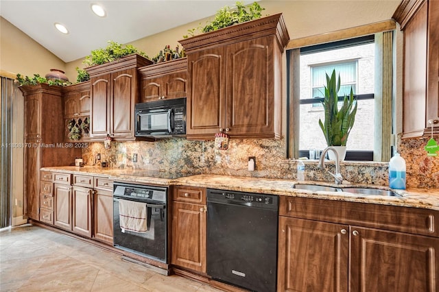 4946 SW 166th Ave, Miramar, FL 33027 - kitchen featuring black appliances, a sink, light stone countertops, decorative backsplash, and lofted ceiling