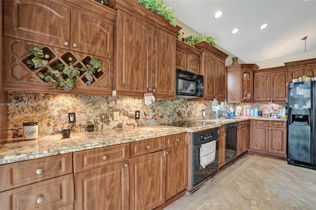 4946 SW 166th Ave, Miramar, FL 33027 - kitchen with black appliances, light stone countertops, a sink, backsplash, and vaulted ceiling