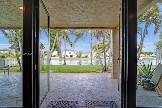 4946 SW 166th Ave, Miramar, FL 33027 - entryway featuring a water view, stone floors, healthy amount of natural light, and a textured ceiling