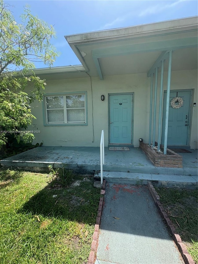 1239 Marseille Dr Unit 7, Miami Beach, FL 33141 - doorway to property featuring stucco siding