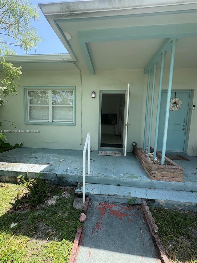 1239 Marseille Dr Unit 7, Miami Beach, FL 33141 - doorway to property featuring stucco siding