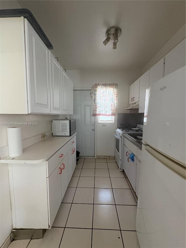 1239 Marseille Dr Unit 7, Miami Beach, FL 33141 - kitchen featuring white appliances, white cabinetry, under cabinet range hood, and light countertops