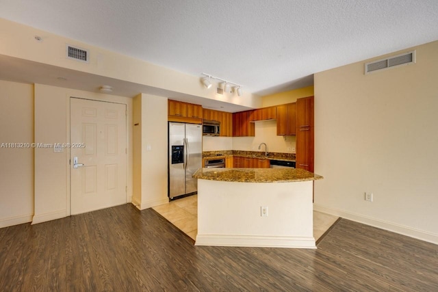 510 NW 84th Ave Unit 541, Plantation, FL 33324 - kitchen with stainless steel appliances, a sink, light wood-type flooring, dark stone countertops, and track lighting