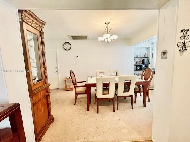 2465 NE 15th Ave, Pompano Beach, FL 33064 - dining room featuring a chandelier and light carpet