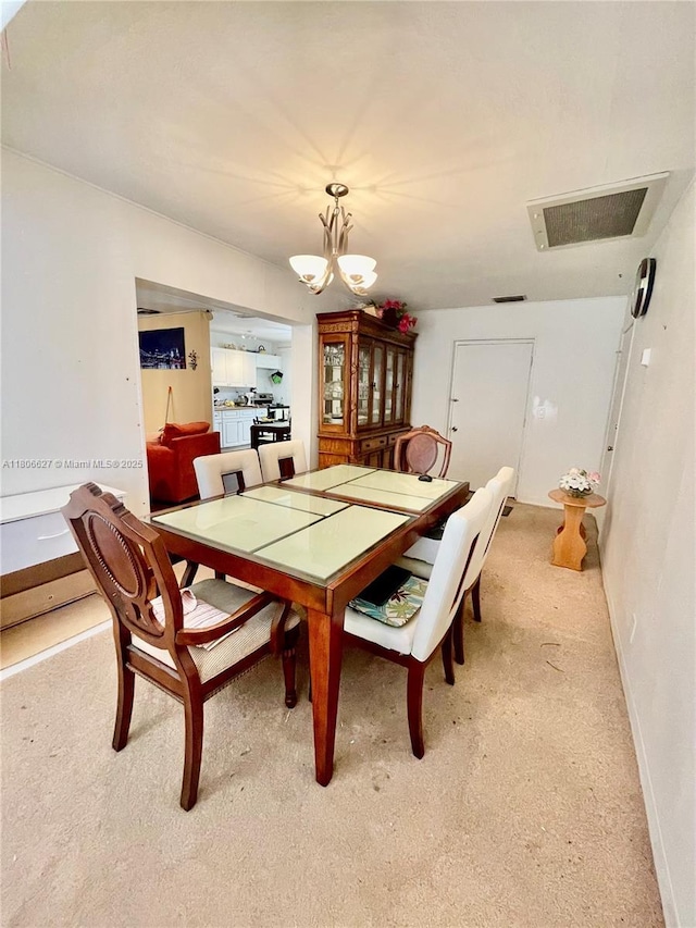 2465 NE 15th Ave, Pompano Beach, FL 33064 - dining space featuring light colored carpet, a chandelier, and baseboards