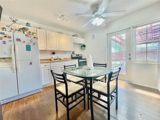 2465 NE 15th Ave, Pompano Beach, FL 33064 - dining room with ceiling fan, light wood-style flooring, and baseboards