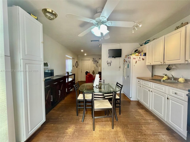 2465 NE 15th Ave, Pompano Beach, FL 33064 - kitchen with a sink, white refrigerator with ice dispenser, ceiling fan, and white cabinetry