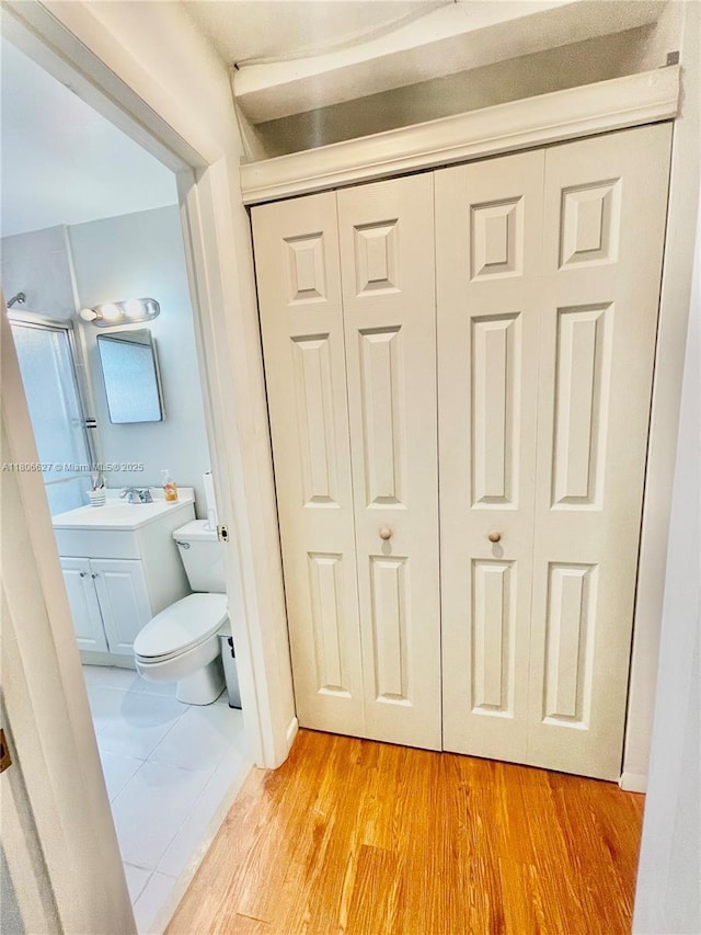2465 NE 15th Ave, Pompano Beach, FL 33064 - bathroom featuring vanity, toilet, and wood finished floors