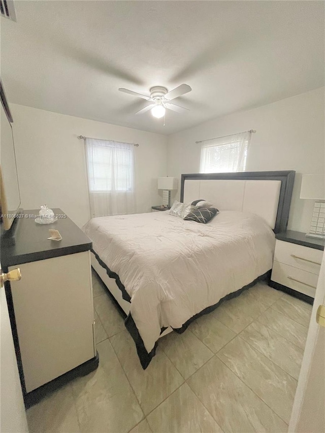 2465 NE 15th Ave, Pompano Beach, FL 33064 - bedroom featuring multiple windows, a ceiling fan, and light tile patterned flooring