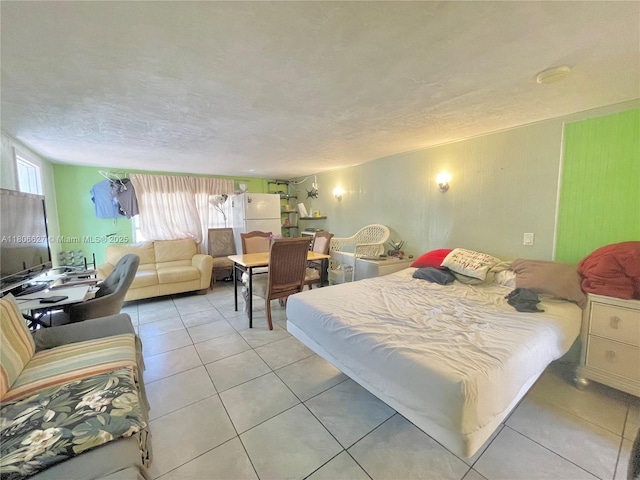 2465 NE 15th Ave, Pompano Beach, FL 33064 - bedroom with light tile patterned floors, freestanding refrigerator, and a textured ceiling