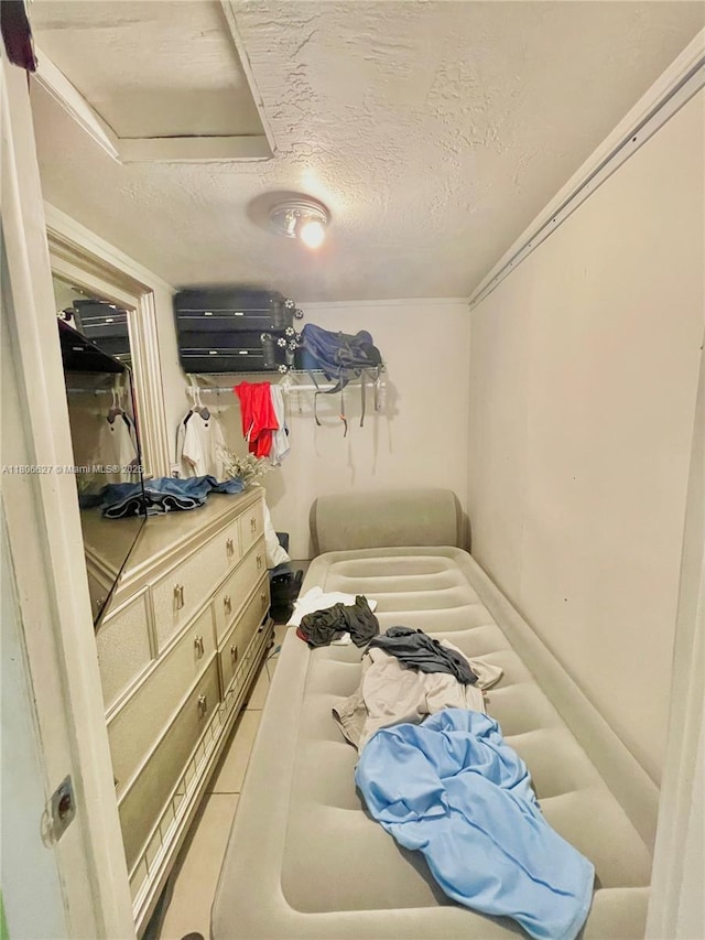 2465 NE 15th Ave, Pompano Beach, FL 33064 - bedroom with a textured ceiling, tile patterned floors, and attic access