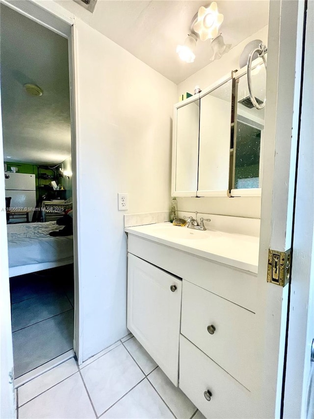2465 NE 15th Ave, Pompano Beach, FL 33064 - bathroom with vanity, tile patterned floors, and ensuite bathroom